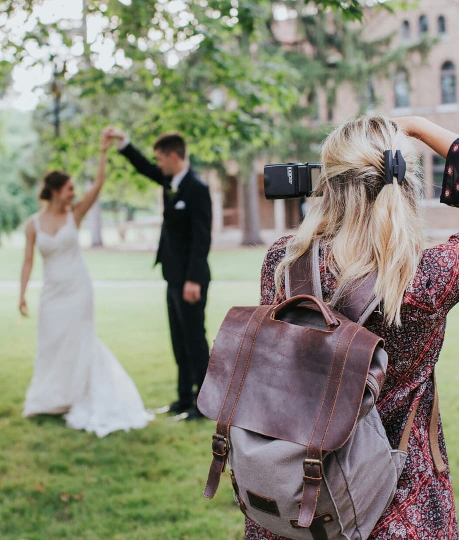 A photographer composing a shot of a bride's portrait, soft window light, intimate.