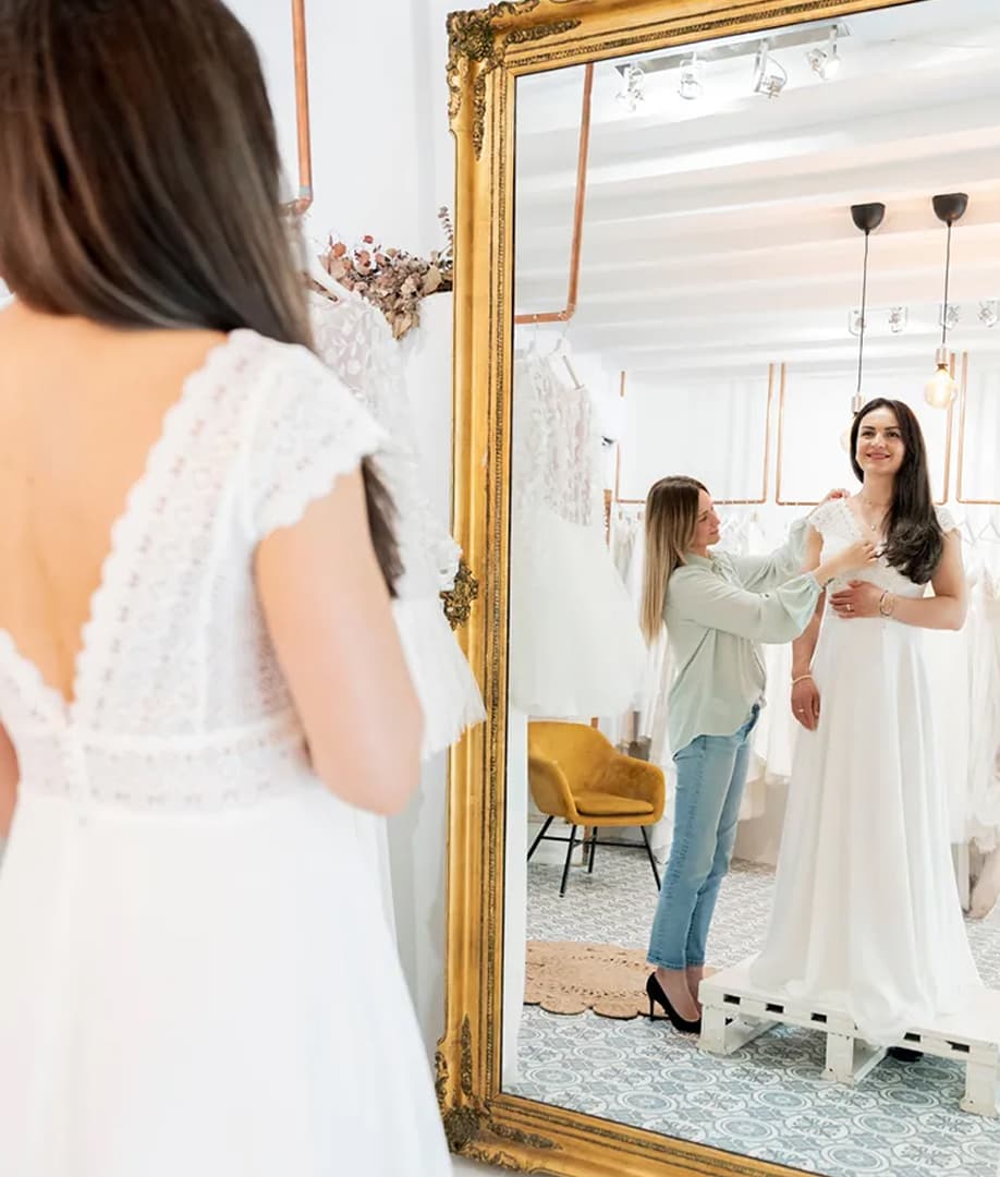 Warm hotelier portrait — soft morning light, uniform rather than business attire.